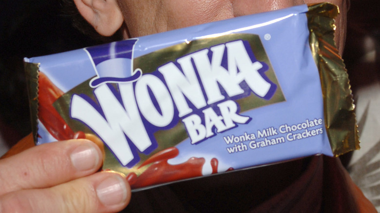 Are Wonka Chocolate Bars Real? Here’s the Truth in 2025 Customer holding Wonka chocolate bar with joy